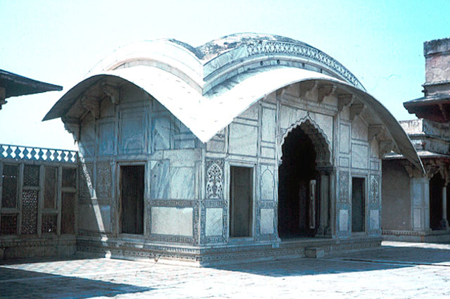 Exterior diagonal view of pavilion; close-up of curved roof and pointed-arch openings