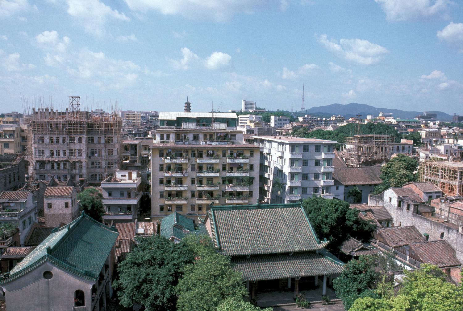 Elevated view of prayer hall among apartment buildings, looking north