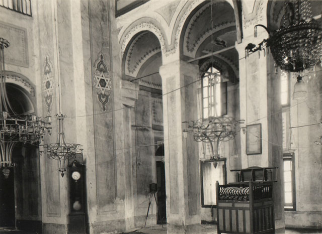 Gül Mosque - Interior view looking north from nave towards the left side gallery, a preacher's seat abuts the gallery pier and the clock in the corner keeps prayer time