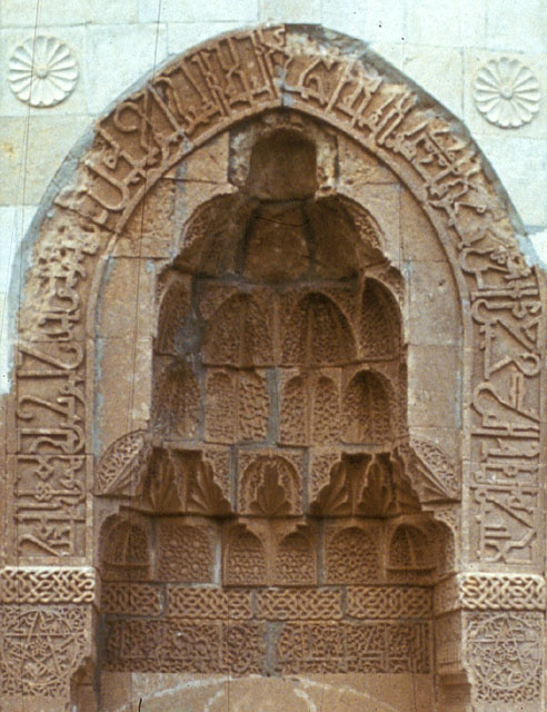 Detail of main portal showing kufic inscription and carved muqarnas semi-vault