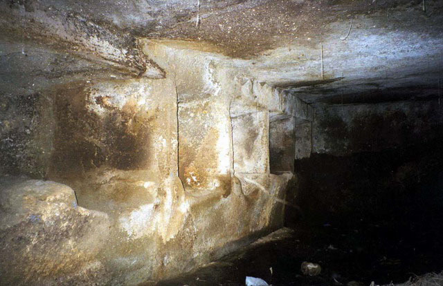Interior view of rock-carved room, before renovation