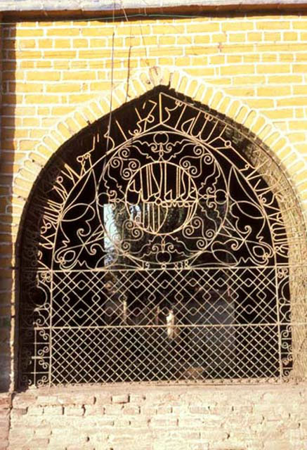 Detail of gateway interior window, with Arabic inscription worked into grille