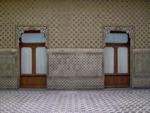 Interior view showing two cusped arch doorways and tilework on wall and floor