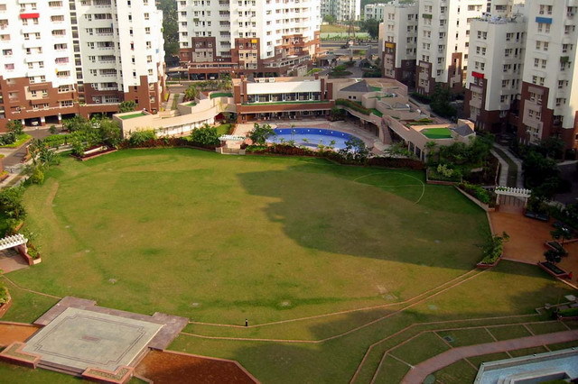 Elevated view of Udita apartment blocks and central green space, looking east towards Club de Ville with pool