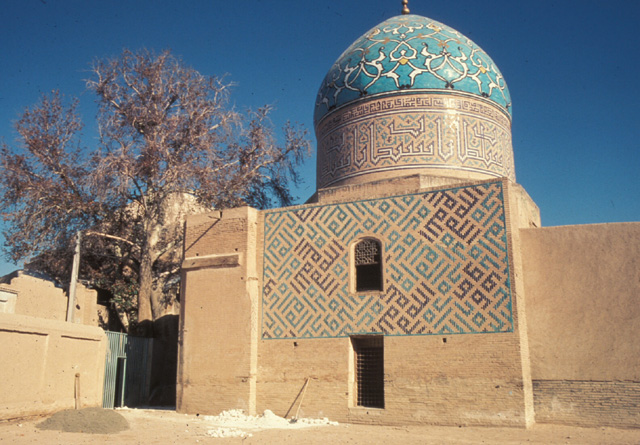 Arabesque ornamented dome with incription bands around the drum