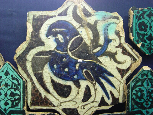 Eight-pointed star tile with bird motif, surrounded with cruciform tiles in turquoise and black (Karatay Museum, Konya)