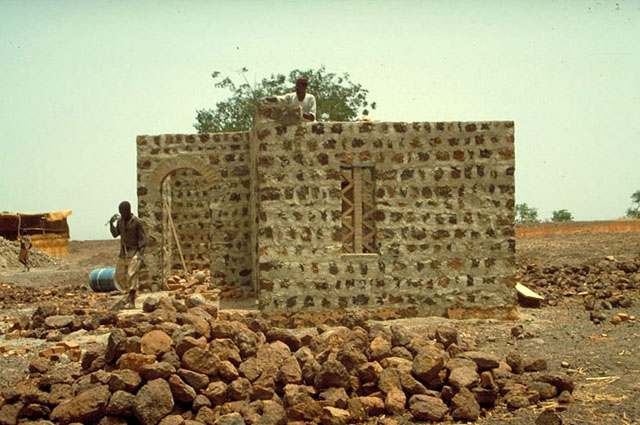 Exterior view, stone house under construction