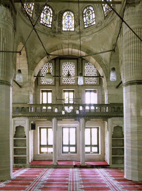 Interior view; west arcade and gallery with built-in bookshelves