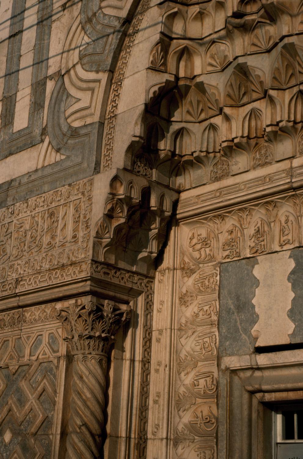 Detail showing muqarnas carving and polychrome joggled voissours