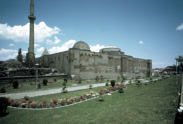 Exterior view from south, showing the ruined hamam on the left and the qibla wall of the mosque
