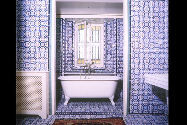 Interior view showing bath engulfed in blue and white tile work