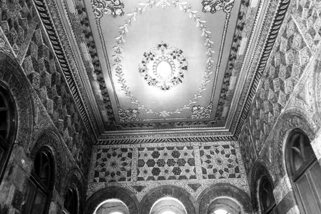 Anbar School Restoration - Interior detail showing carved wall and ceiling design with arches hinted at