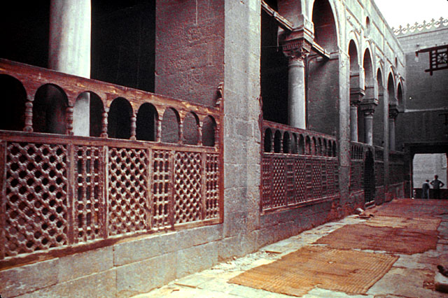 Interior view showing wooden mashrabiya screen separating the ablution court from the mosque