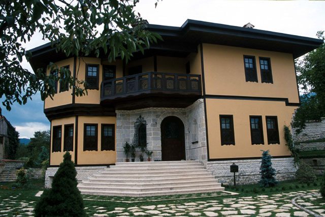 Exterior view showing stucco and stone façade