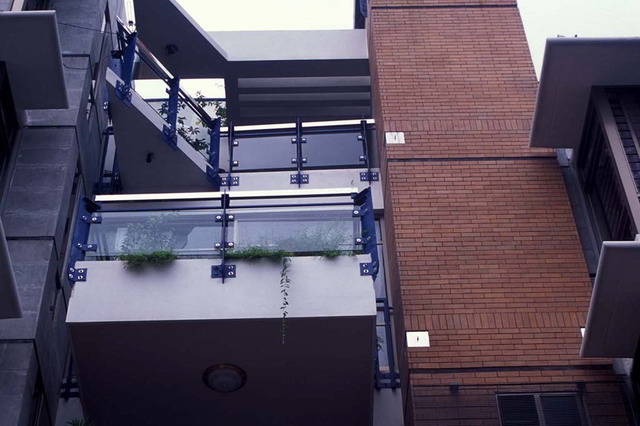 Exterior detail, brick wall and balconies with glass balustrades