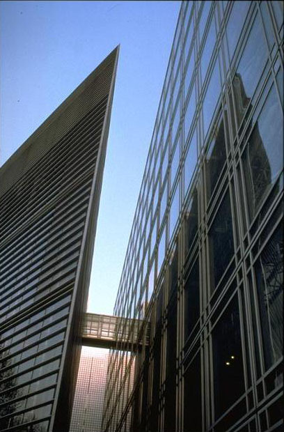 Façade; the two, glass-clad wings of the Institute are separated by a narrow east-west slit ending in an interior court