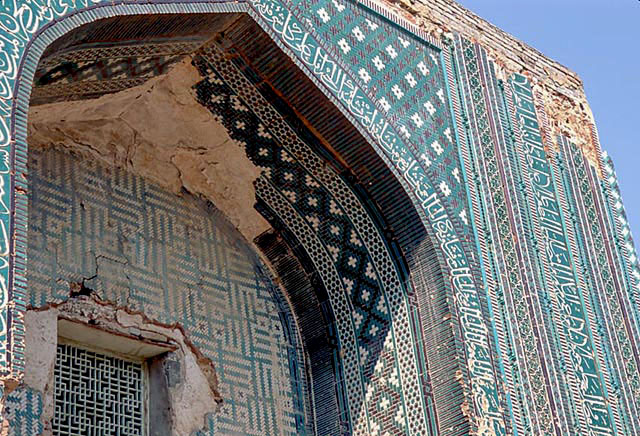 Exterior detail of portal showing tile mosaic with geometric motifs and inscriptions