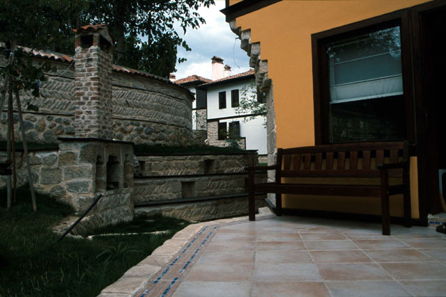 Exterior view, showing stone fireplace and patio