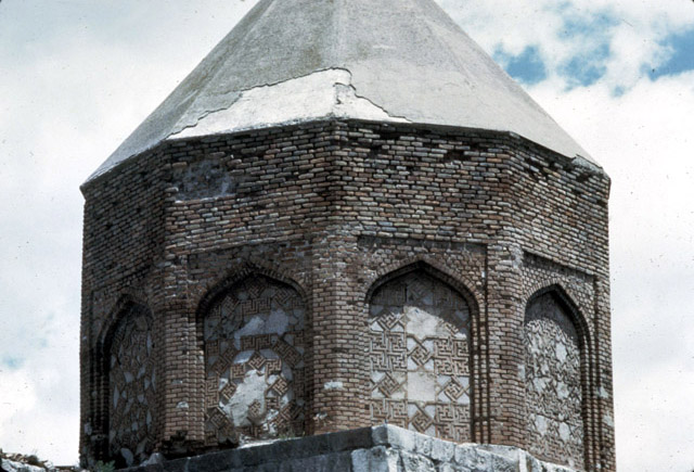 Exterior view of tomb tower, showing decagonal drum and conical vault.