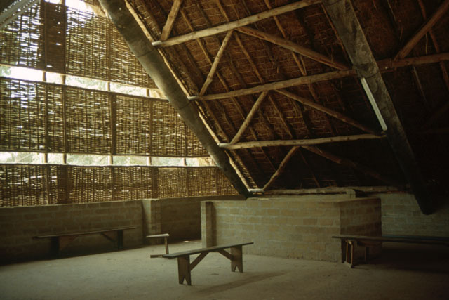 Interior detail showing contrast between wood and thatch pitched roof and use of bamboo screens