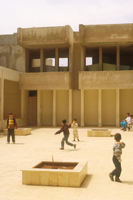 Islamic Orphanage - Exterior view showing courtyard with fountains and planters