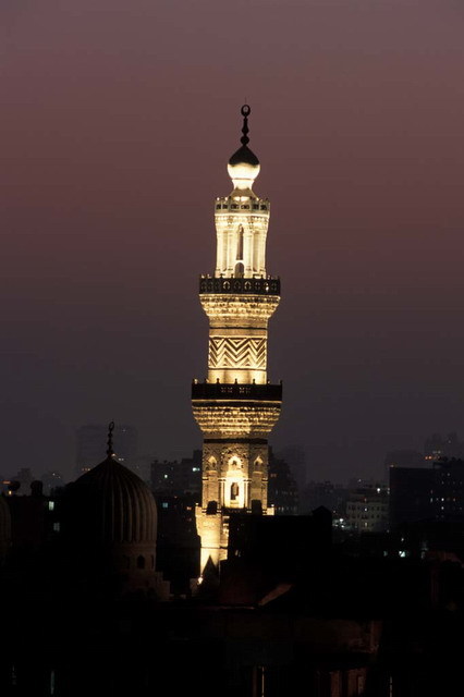 Night view of restored minaret with dramatic lighting