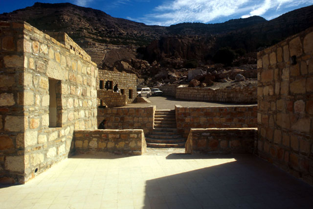 Exterior view, showing paths between stone buildings