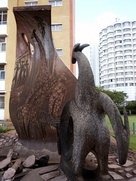 Sculpture on university grounds. The Safari Club Hotel appears in the background