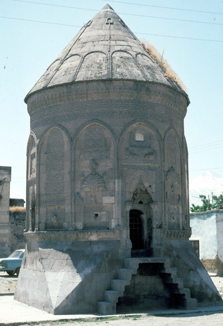 Exterior view from north with entrance, showing tomb surrounded by houses that have since been demolished