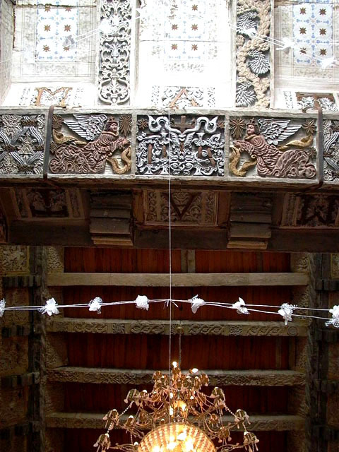 Interior view of juncture between two carved wood ceilings (artesonado)