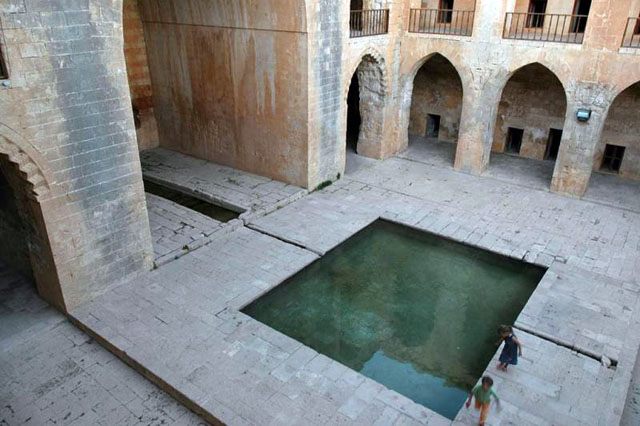 Elevated view of madrasa courtyard showing pool before grand iwan