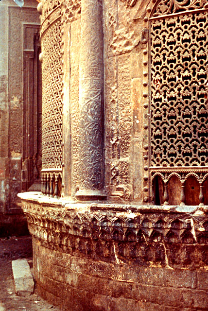 Exterior detail showing muqarnas base and ornate grills of sabil windows