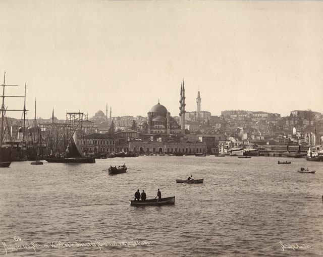 Exterior view from Golden Horn looking southwest, with the customshouse (rüsumat dairesi) seen before the mosque. In the background, the Beyazit fire tower (right) and the mosque of Bayezid II (left)