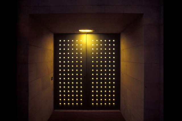 Entrance with metal door, lit at night