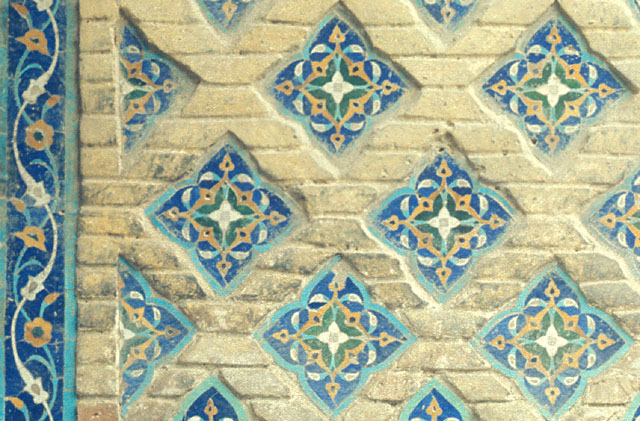 Detail of diamond patterned brickwork inlaid with tile mosaic, intrados of southeast iwan