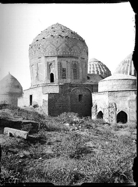 Exterior view of the rear from the northeast. The octagonal mausoleum stands on the right. The ribbed domes of the Amirzadeh and Shad-i Mulk Aqa mausolea are visible in the background. The dome to the left of the Shirin Biqa Aqa belongs to the anonymous mausoleum III