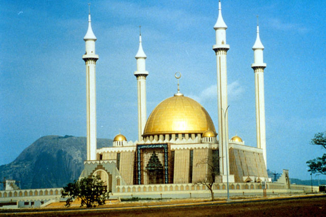 Exterior view showing gold dome and corner minarets