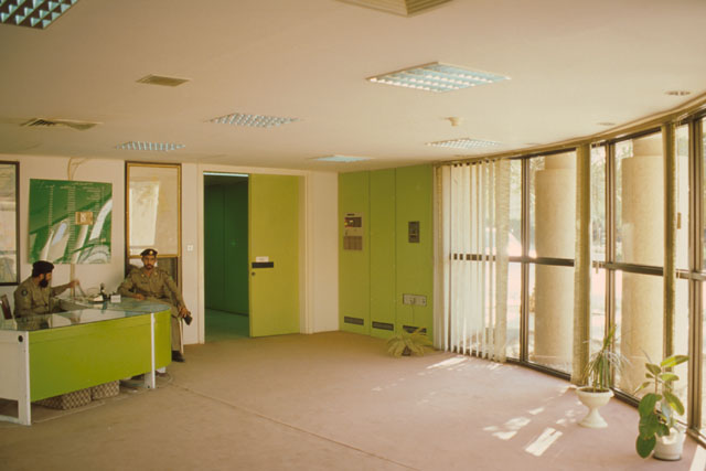 Interior view showing reception area set beside wall of glazing