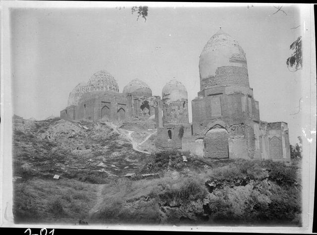 View from the southwest. Up the hill stands the Amirzadeh mausoleum with the ribbed dome. The dome to the right of it belongs to the Amir Husayn ibn Tughluq Tekin mausoleum. The dome furthest left in the background belongs to the Shad-i Mulk Aqa mausoleum