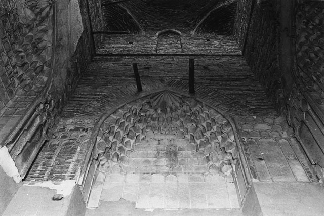 Interior view  of tomb chamber showing muqarnas crown of niche on wall