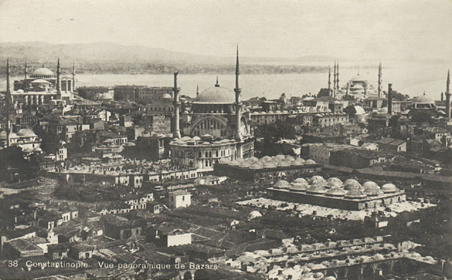 General view looking east from a minaret of the Bayezid Mosque; the Old Bedesten with its fifteen domes appears in front of the Sandal Bedesten, seen immediately to the left of the Nuruosmaniye Mosque at center.  The Hagia Sophia and the Sultanahmet Mosque occupy the background to the left and right