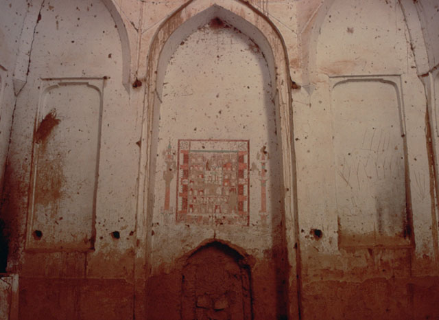 Interror view of western wall, showing central niche with painted depiction of a walled city and two minarets