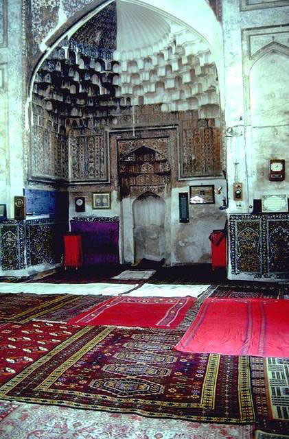 Interior view of the qibla wall with mihrab and muqarnas semi-dome