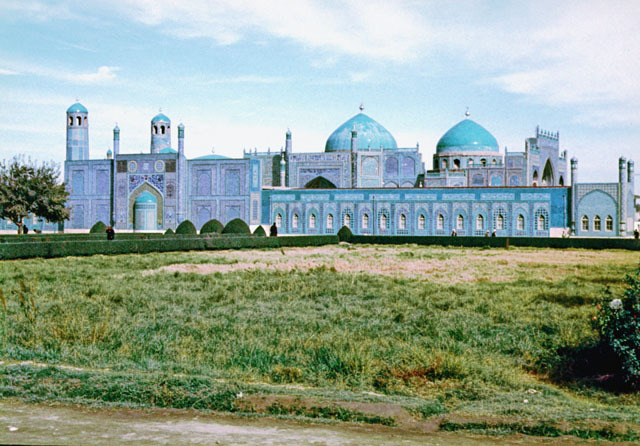 General view of complex from southwest, showing qibla wall of new mosque with shrine domes rising in the background