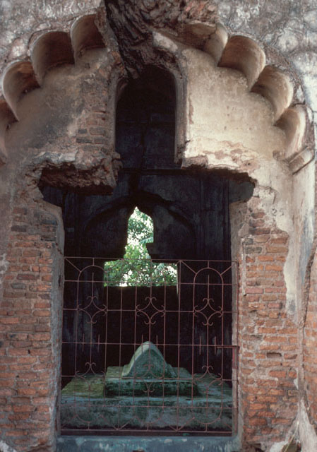 Tomb visible through multifoil arch doorway of south elevation