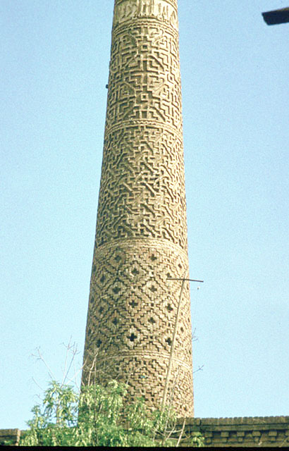 Detail of minaret showing brickwork and inscriptive band