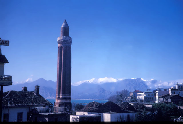 Exterior view from northeast, showing minaret and mosque domes with Antalya bay seen in the background