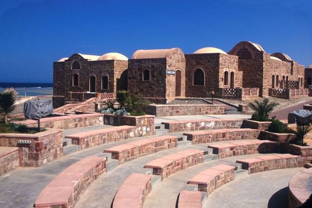 Exterior view showing theatre seats and stone huts