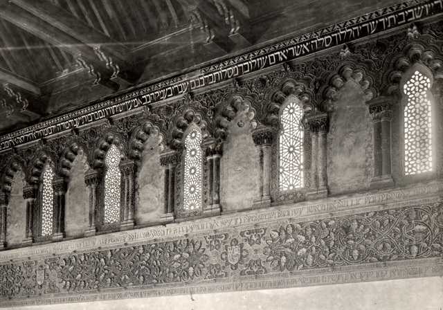 Sinagoga del Tránsito - Interior view showing polylobed arched windows and blind-arches,  foliate ornamentation, the coat-of-arms of Castille, and Hebrew inscriptions