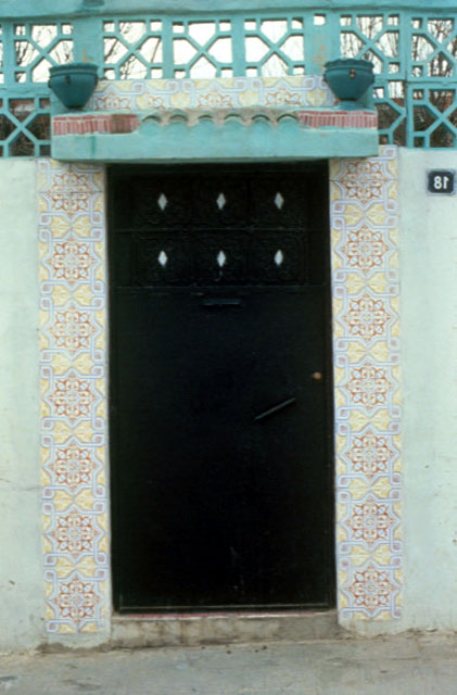 Decorated doorway leading to a courtyard of a house